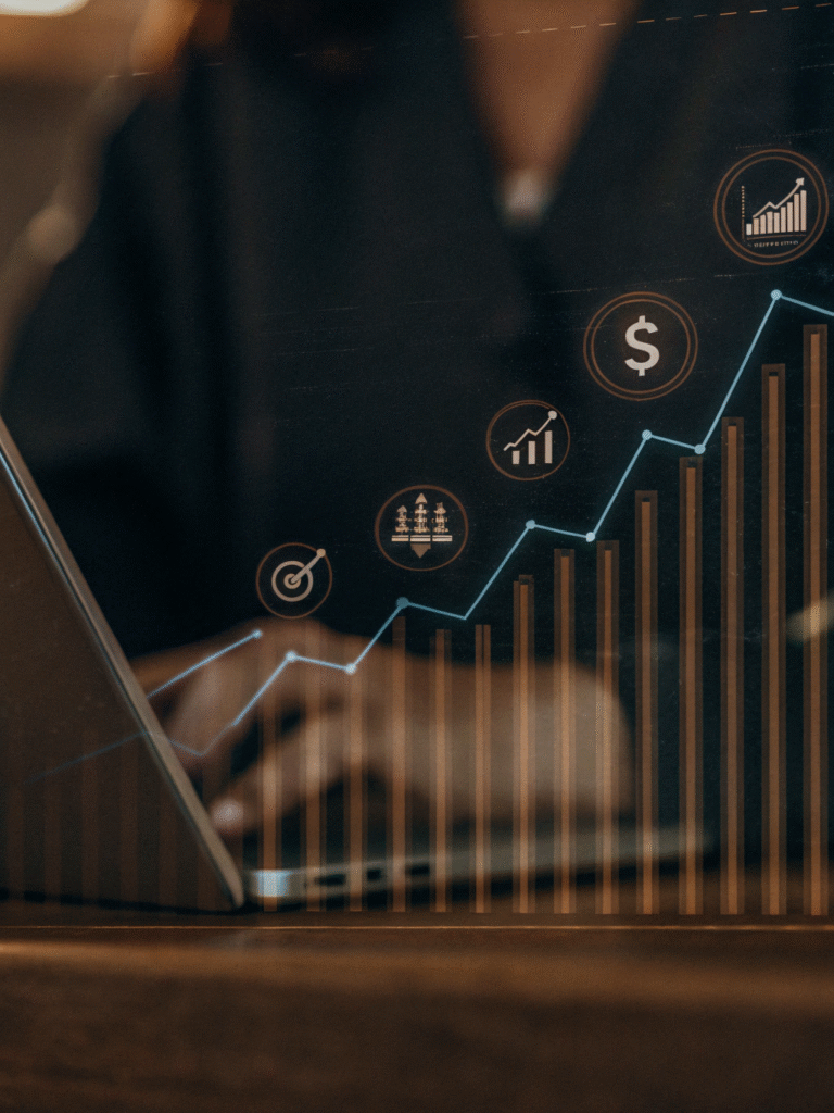 The growth chart and SEO symbols that overlap the figure of a working specialist are a metaphor for stable, predictable digital performance.